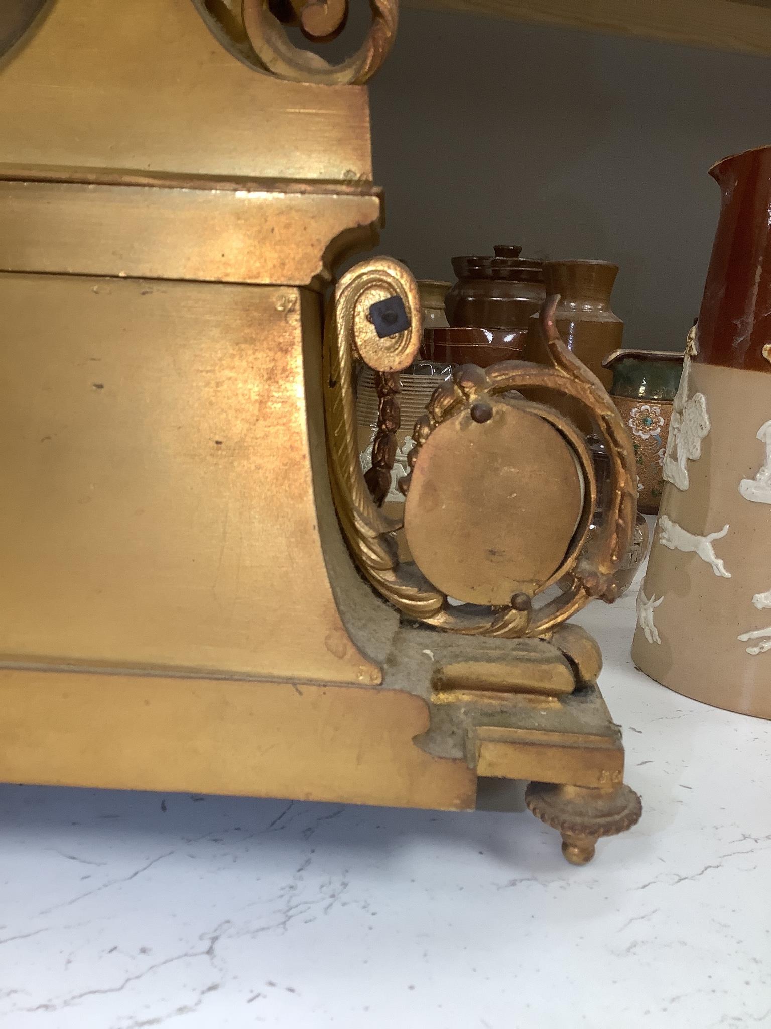 A 19th century French ormolu and Sevres style porcelain mounted mantel clock, with key and pendulum, 35 cm high